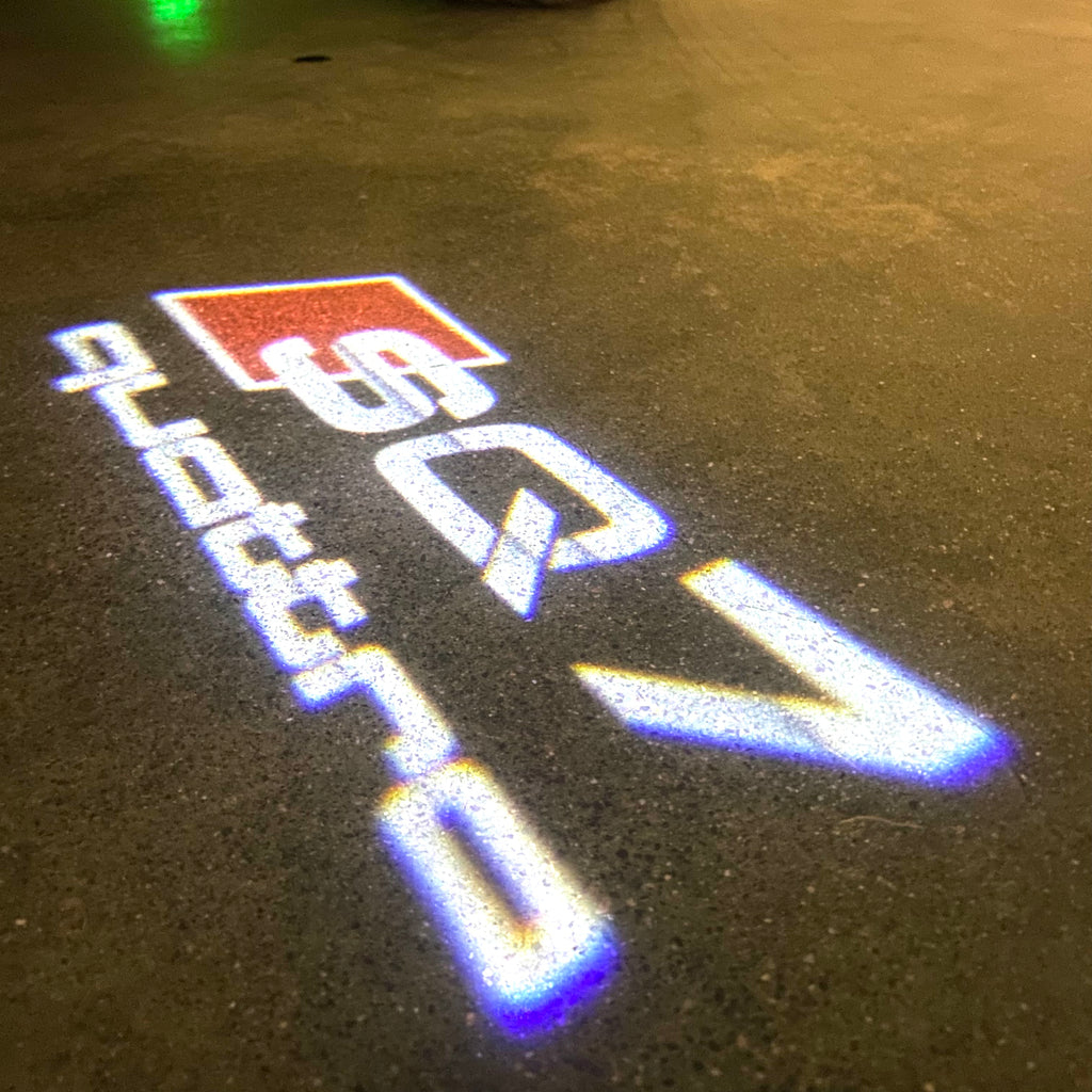 LUCES DE PROYECTOR LOGO AUDI No 120 (cantidad 1 = 2 películas con logotipo / 2 luces de puerta)