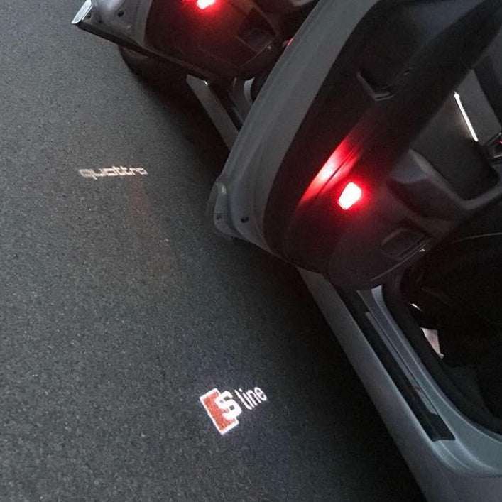 AUDI LOGO PROJECTOT LIGHTS Nr.100 (الكمية 1 = 2 Logo Films /2 أضواء الباب)