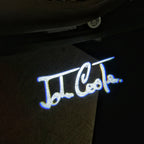 LUCES DE PROYECTOR CON LOGO JOHN COOPER Nr.84 (cantidad 1 = 2 Película con Logo / 2 luces de puerta)