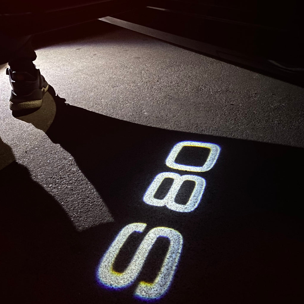 LUCES DEL PROYECTOR DEL LOGOTIPO Volvo Nr. 90 (cantidad 1 = 2 Película del logotipo / 2 luces de puerta)